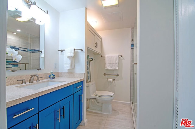 bathroom with tile patterned floors, vanity, toilet, and an enclosed shower