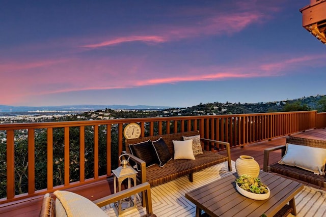 deck at dusk featuring an outdoor hangout area