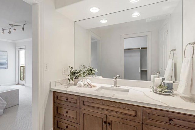 bathroom with vanity, ornamental molding, and track lighting