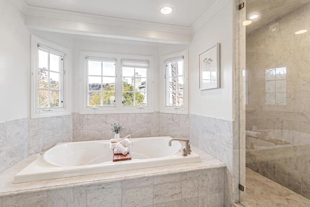 bathroom with ornamental molding, shower with separate bathtub, and a wealth of natural light