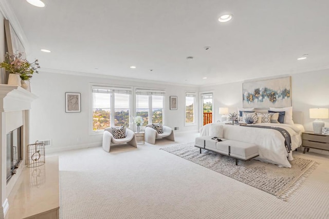 bedroom featuring crown molding, light colored carpet, and a premium fireplace