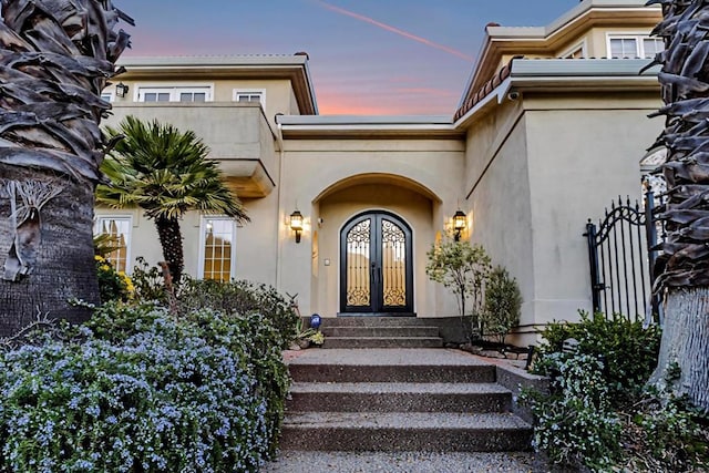 view of exterior entry at dusk