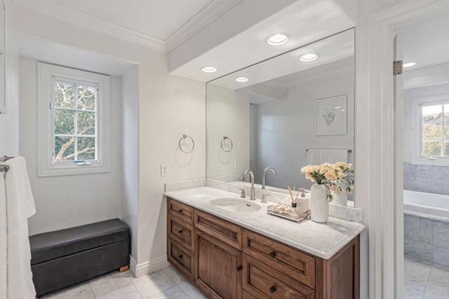 bathroom with a relaxing tiled tub, tile patterned floors, ornamental molding, and vanity