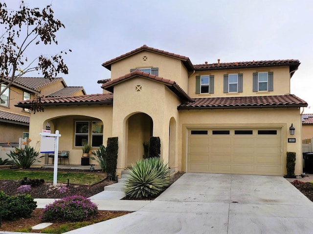 mediterranean / spanish-style house featuring a garage