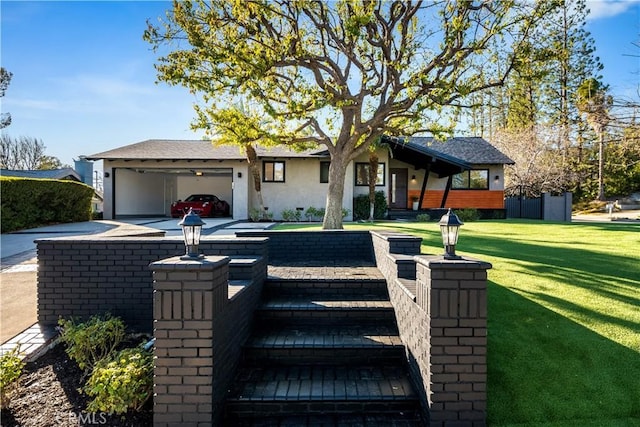 ranch-style house featuring a garage and a front yard