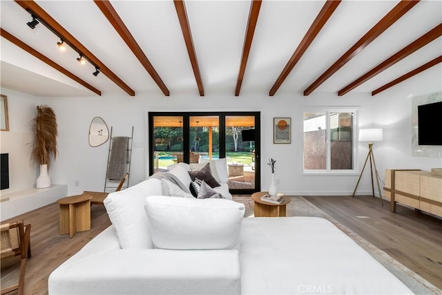 living room with hardwood / wood-style flooring and beam ceiling