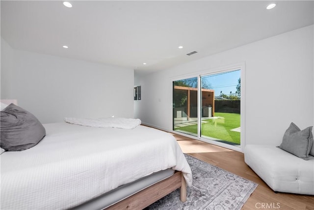 bedroom with access to exterior and light wood-type flooring