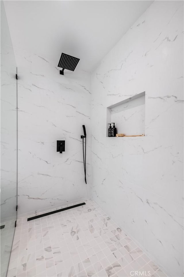 bathroom with tiled shower