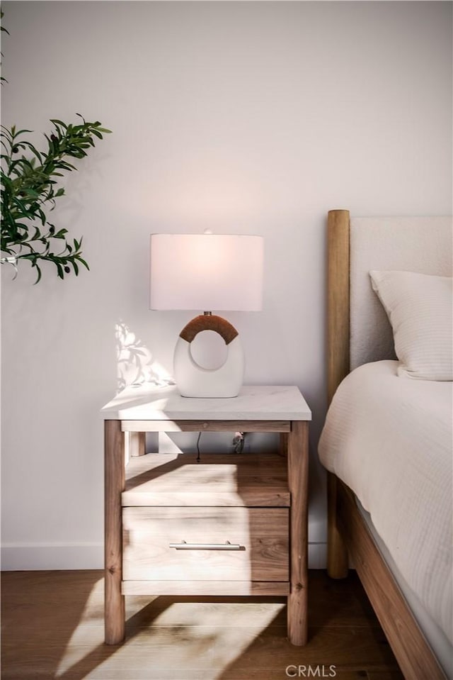 bedroom with dark hardwood / wood-style floors