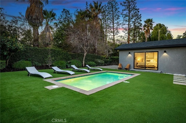 pool at dusk with a yard