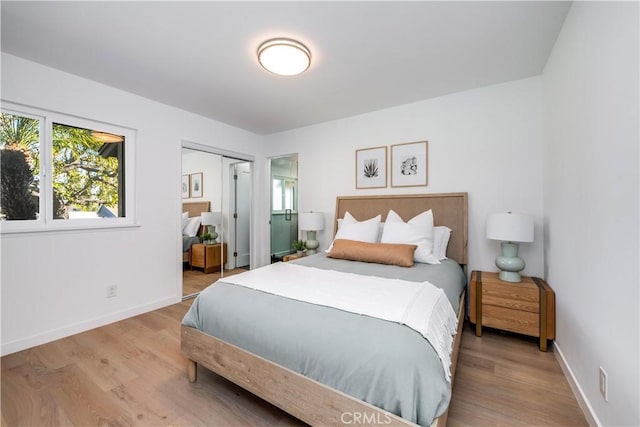 bedroom with a closet and light hardwood / wood-style flooring