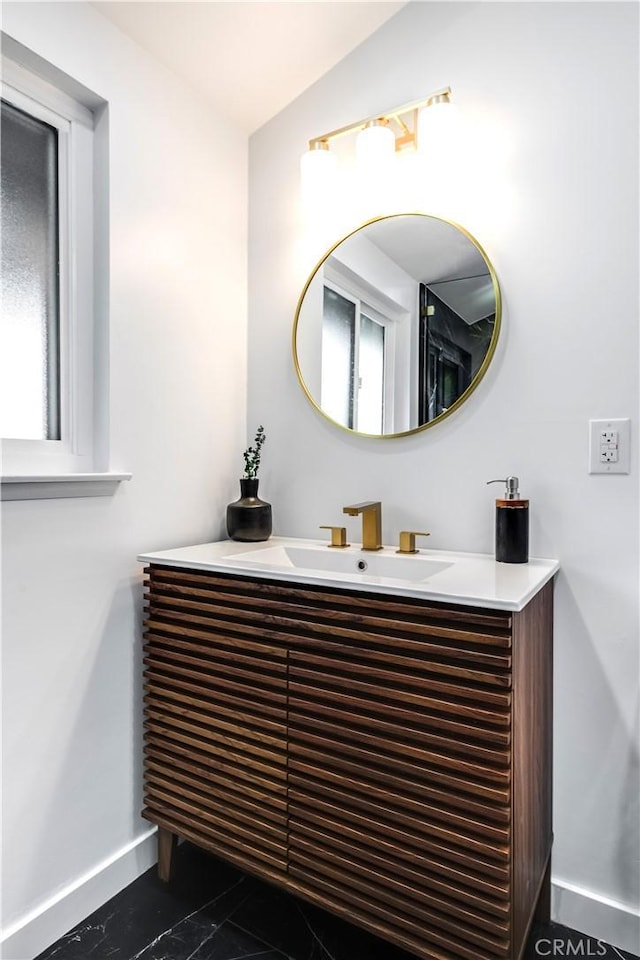 bathroom featuring vanity and lofted ceiling