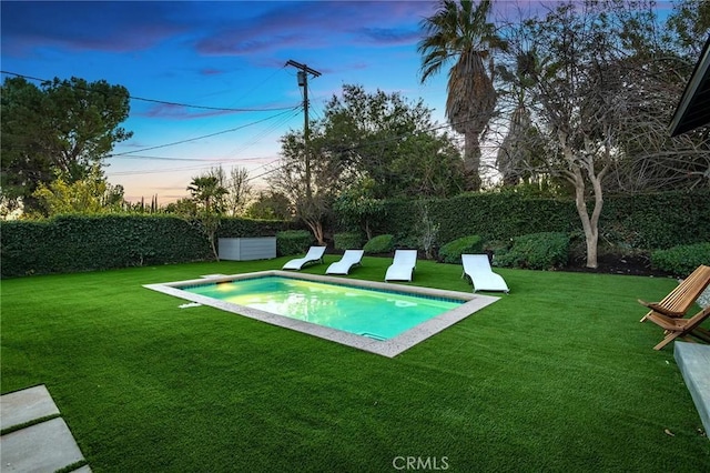 pool at dusk with a yard