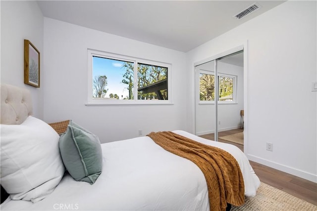 bedroom with hardwood / wood-style flooring and a closet