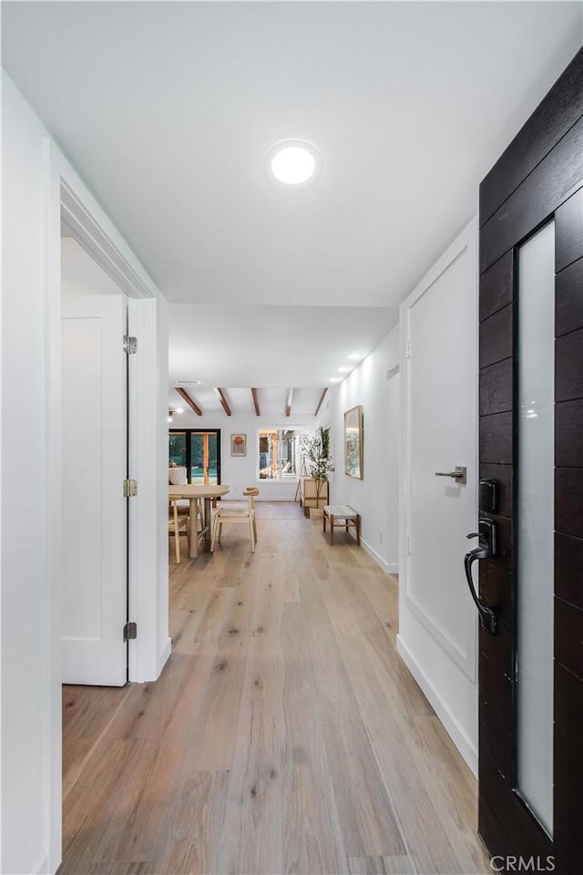 corridor with light hardwood / wood-style floors