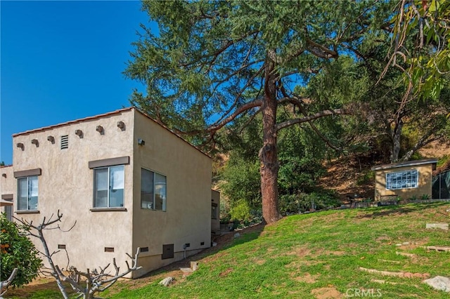 view of side of home featuring a lawn