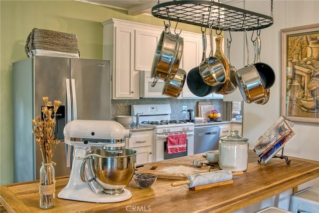 kitchen with white cabinetry, decorative backsplash, and appliances with stainless steel finishes