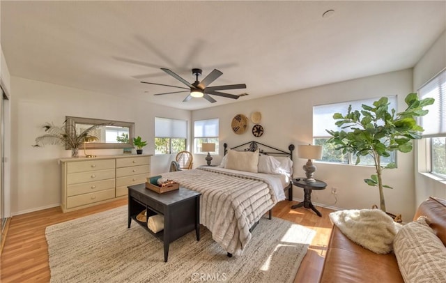 bedroom with ceiling fan and light hardwood / wood-style flooring