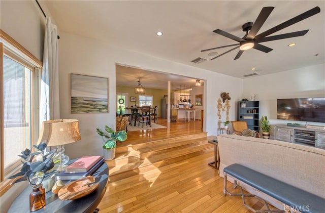 living room featuring ceiling fan and light wood-type flooring