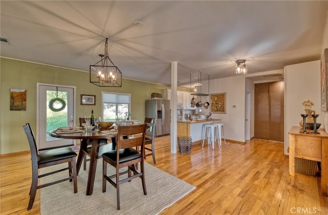 dining room featuring an inviting chandelier and light hardwood / wood-style floors