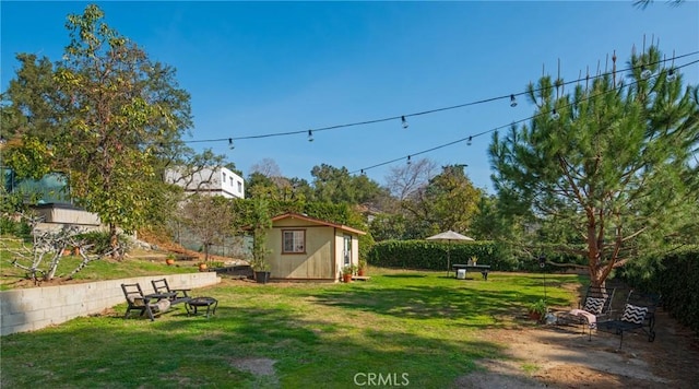 view of yard featuring a storage unit and a fire pit