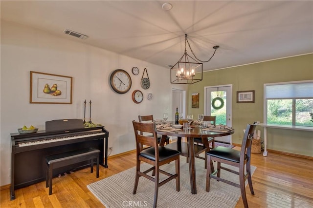 dining room featuring a chandelier and light hardwood / wood-style floors