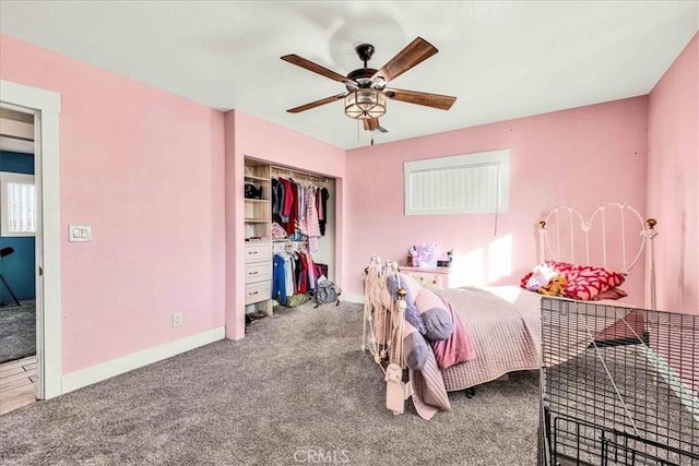 carpeted bedroom with ceiling fan and a closet