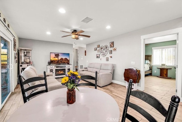 dining area featuring ceiling fan and light hardwood / wood-style flooring