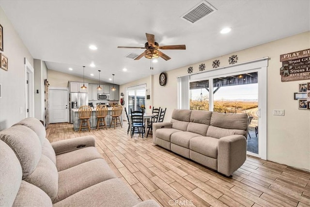 living room with vaulted ceiling and ceiling fan