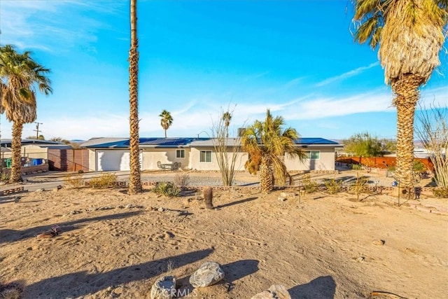 ranch-style home with solar panels