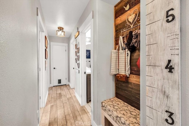 mudroom with light hardwood / wood-style floors