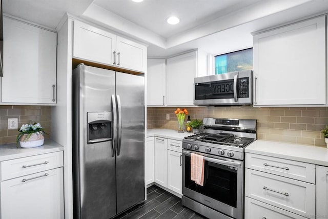 kitchen with appliances with stainless steel finishes, decorative backsplash, and white cabinets