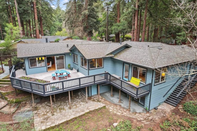 back of house with a wooden deck