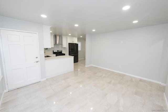 kitchen featuring wall chimney range hood, white cabinetry, electric range, black refrigerator with ice dispenser, and kitchen peninsula