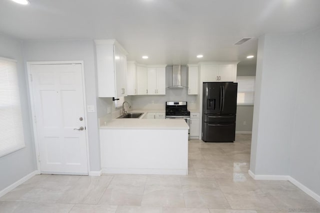 kitchen featuring white cabinetry, sink, black fridge with ice dispenser, stainless steel gas range oven, and wall chimney exhaust hood