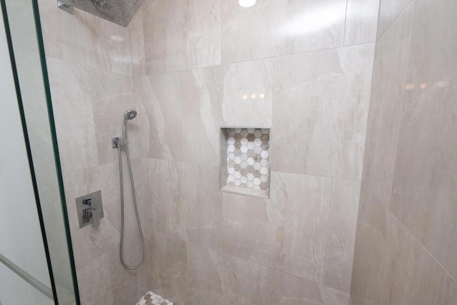 bathroom with tiled shower