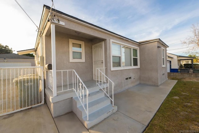 view of front of house featuring central AC unit and a patio