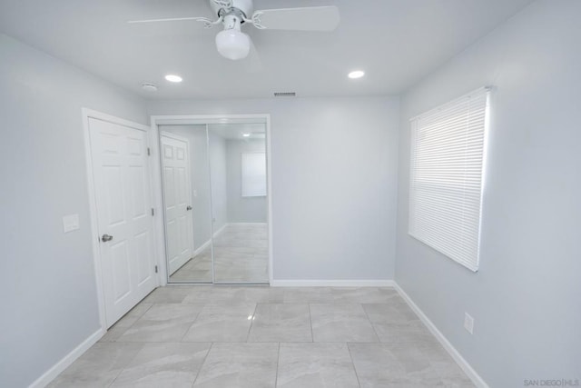 unfurnished bedroom featuring ceiling fan and a closet