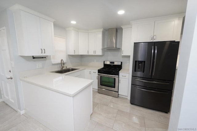 kitchen featuring wall chimney exhaust hood, sink, stainless steel gas range oven, white cabinetry, and black refrigerator with ice dispenser