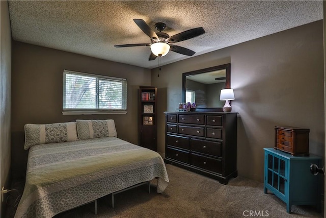 carpeted bedroom featuring a ceiling fan and a textured ceiling