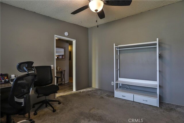 office area with ceiling fan, carpet floors, and a textured ceiling