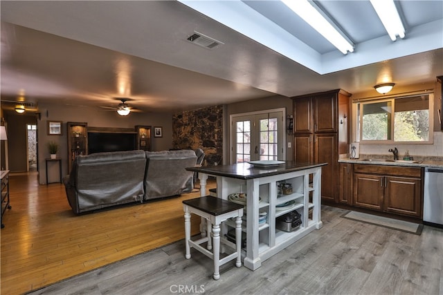 kitchen featuring light wood finished floors, french doors, a wealth of natural light, and visible vents