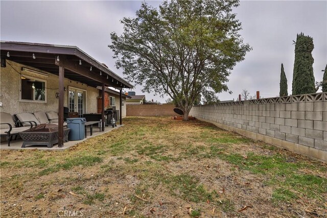 view of yard with an outdoor fire pit