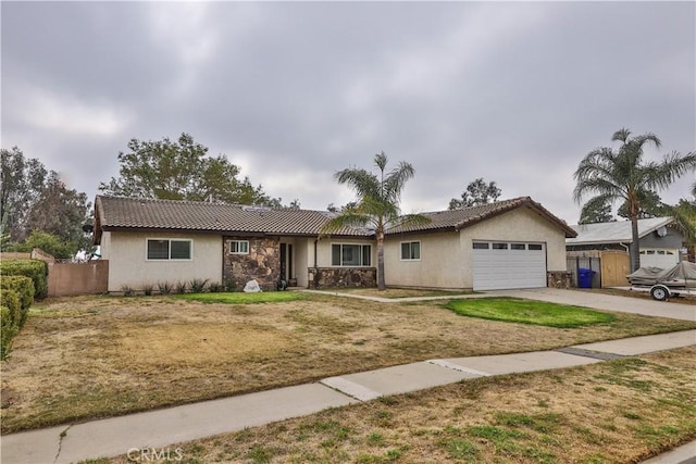 single story home featuring an attached garage, fence, concrete driveway, a tiled roof, and stucco siding