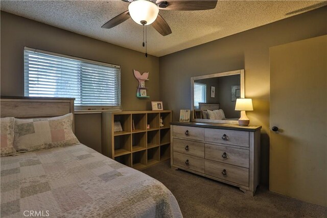 carpeted bedroom with multiple windows, ceiling fan, and a textured ceiling