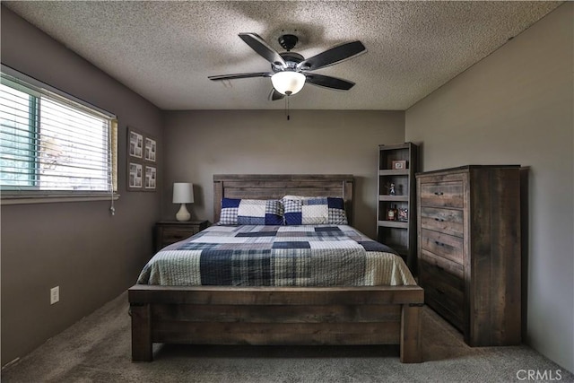 carpeted bedroom with a textured ceiling and a ceiling fan