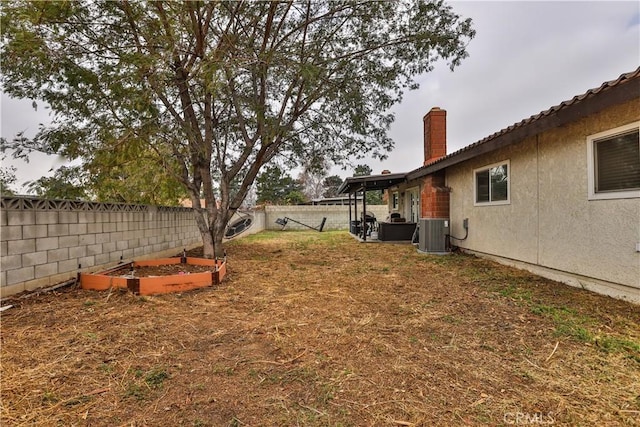 view of yard with a garden, a fenced backyard, and cooling unit