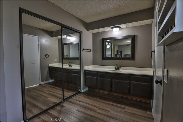 bathroom with vanity, hardwood / wood-style floors, and a textured ceiling