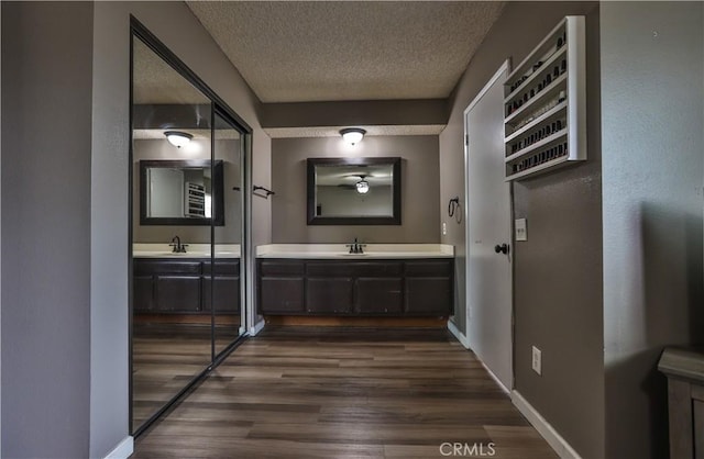 bathroom with vanity, hardwood / wood-style floors, and a textured ceiling