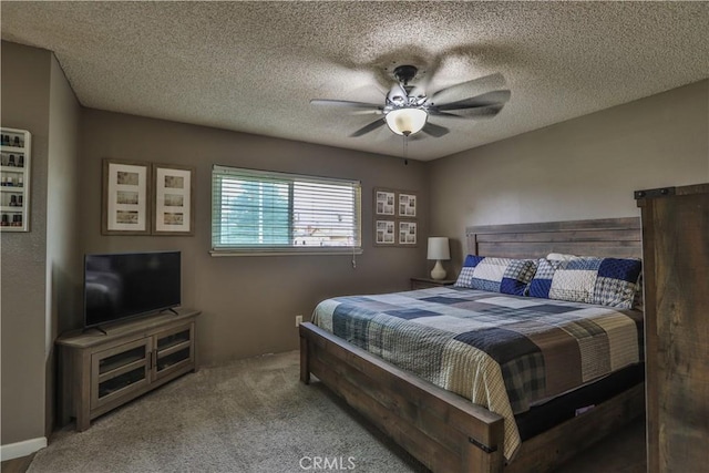 bedroom featuring ceiling fan, carpet floors, and a textured ceiling